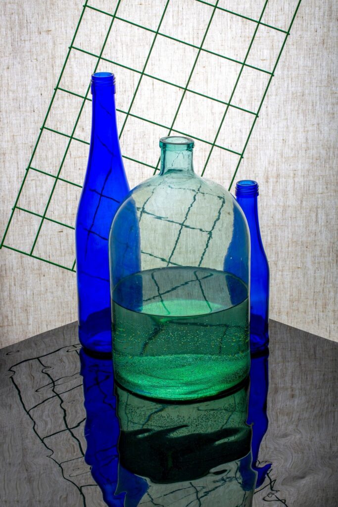 Still life with blue bottles and a jar with water